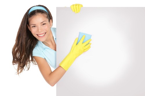 Professional using carpet cleaning machine in a controlled work area
